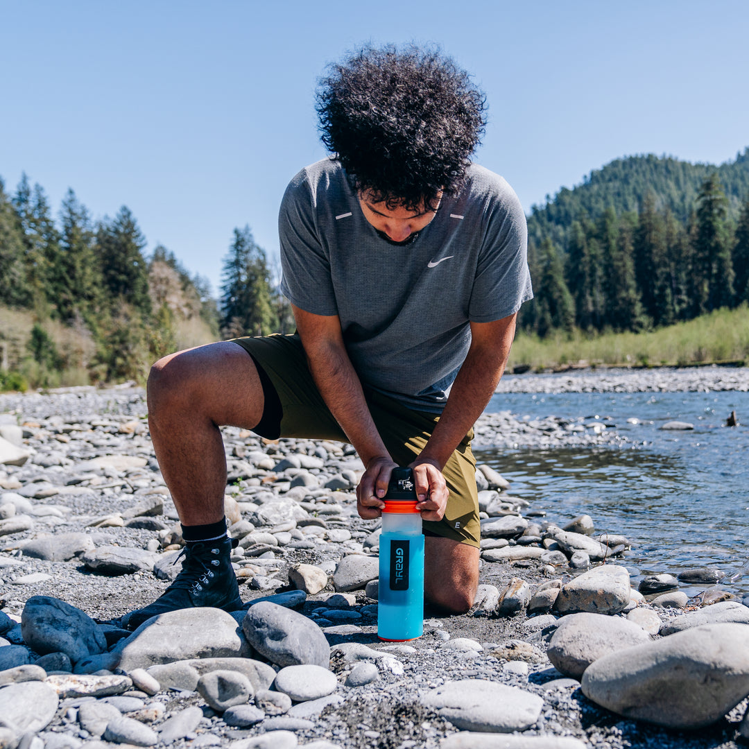 Pressing the GeoPress Bali Blue after filling from a trail creek.