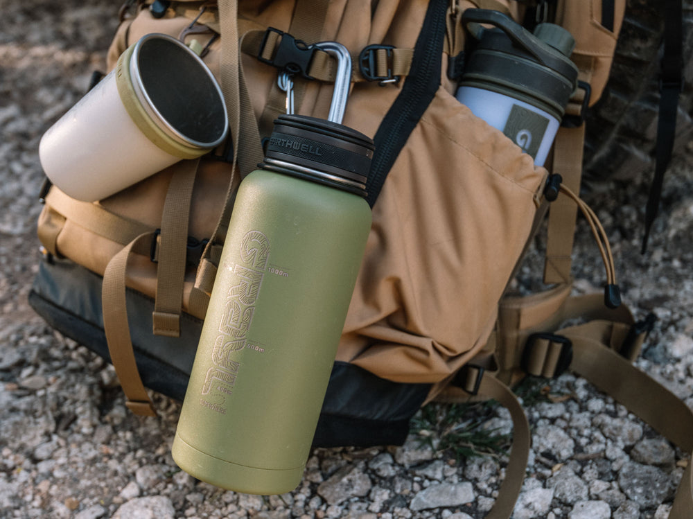 Grayl x Earthwell 32oz Kewler Bottle, Camp Cup and GeoPress equipped to a Mountainsmith backpack.