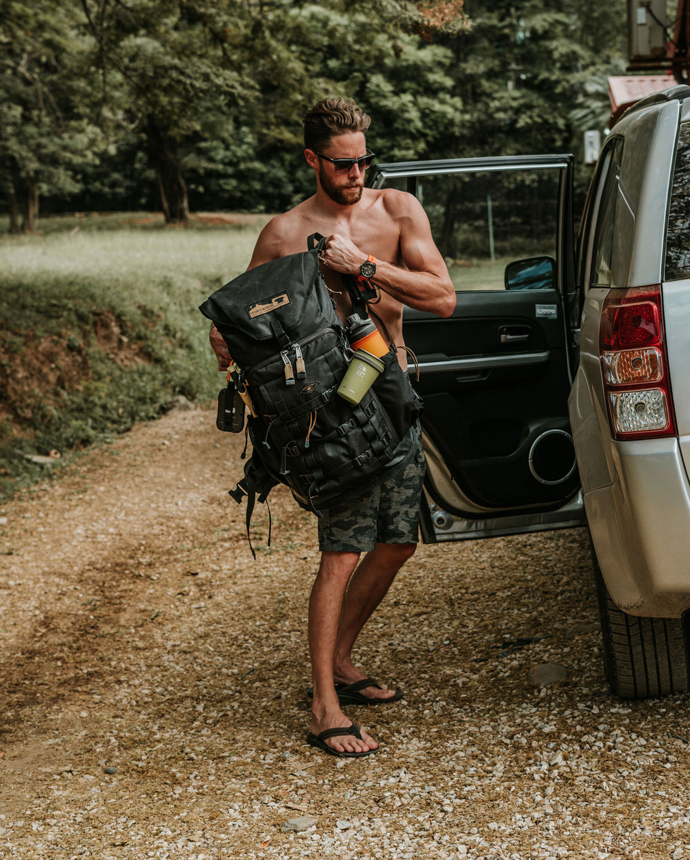 Grayl ambassador Kyle Murphy loading a pack into a vehicle in Guatemala.