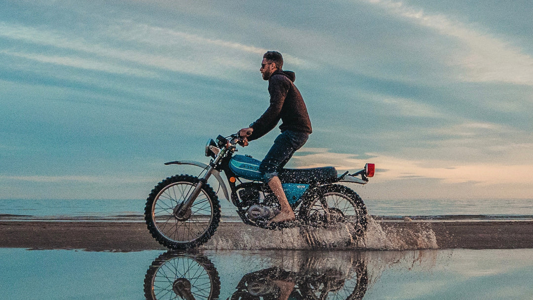 Ambassador Kyle Murphy hauling ass on his vintage Honda motorcycle across the Baja Coast.