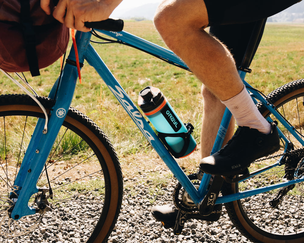 as fits perfect in Arundel® Adjustable Looney Bin bike bottle cage. Bali Blue GeoPress on gravel bike along river's edge.