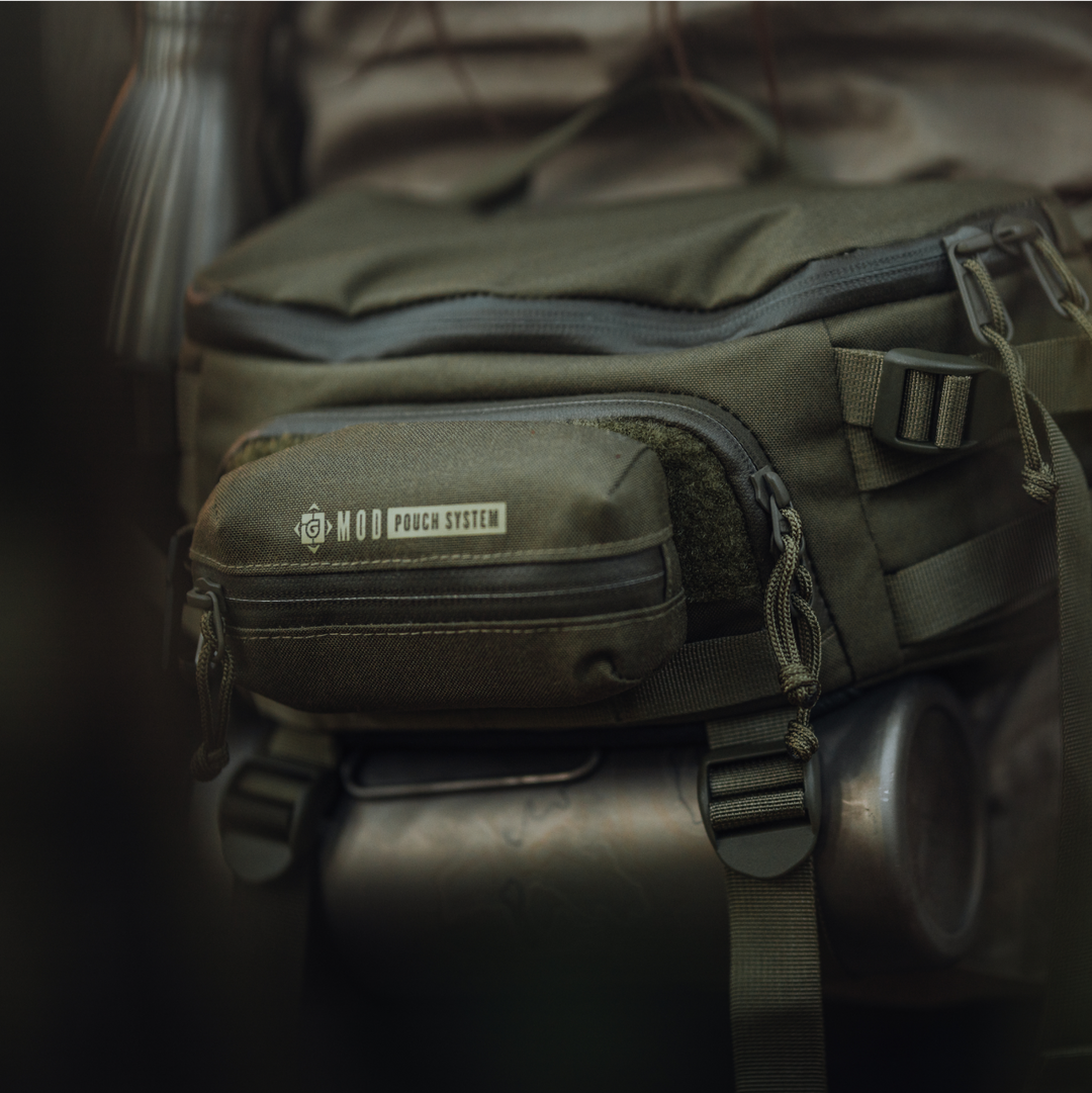 G-MOD Pod Pouch in Olive Drab attached to Mission Hip Pack with GeoPress® Titanium Bottle in BottleLock tie downs.