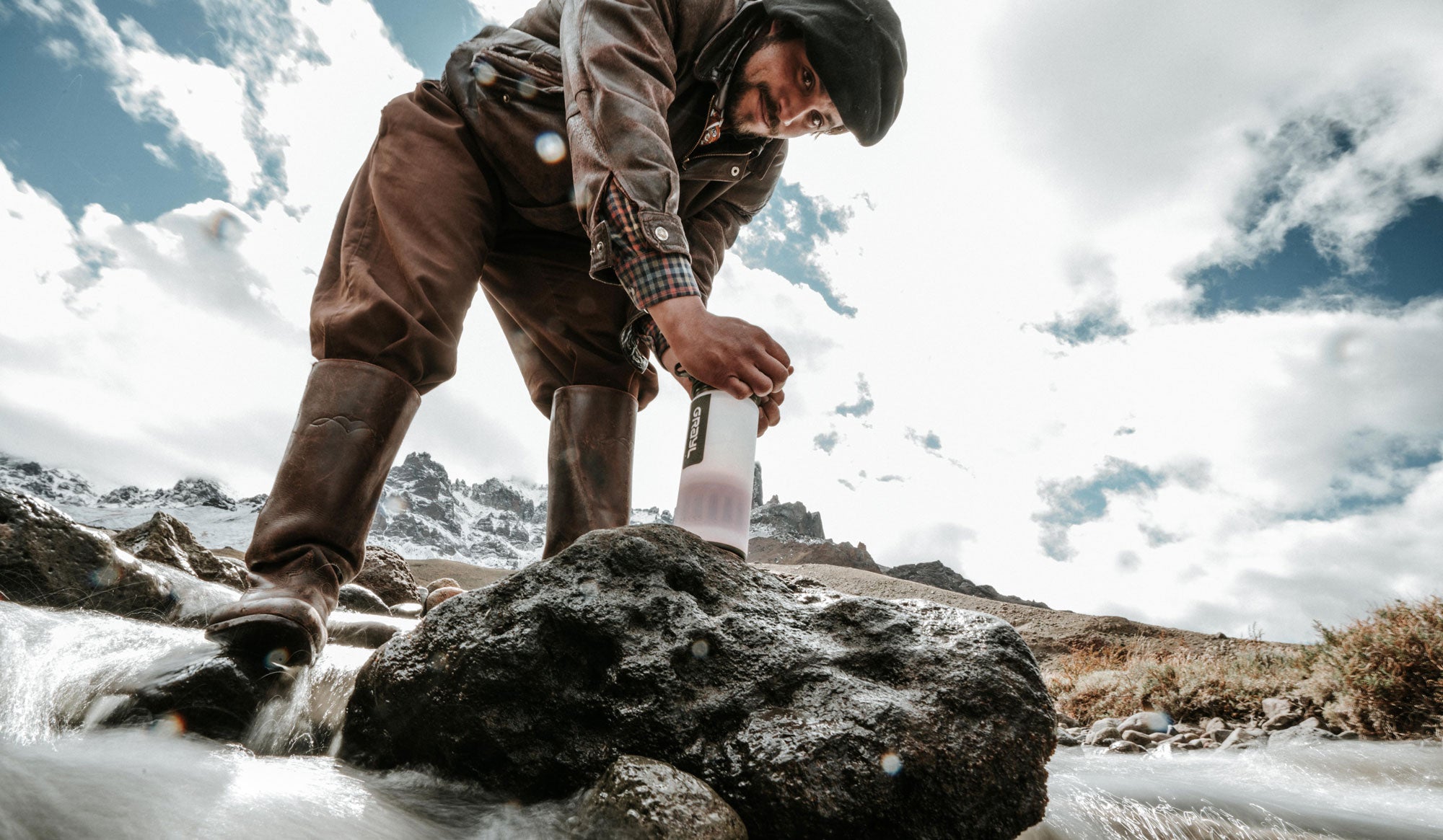 Adventurer in Patagonia purifier water with their Grayl GeoPress.